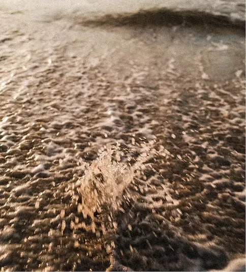 Wave washing over the sand at the shoreline